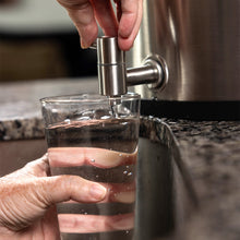 A glass being filled with water from the Alexapure Pro